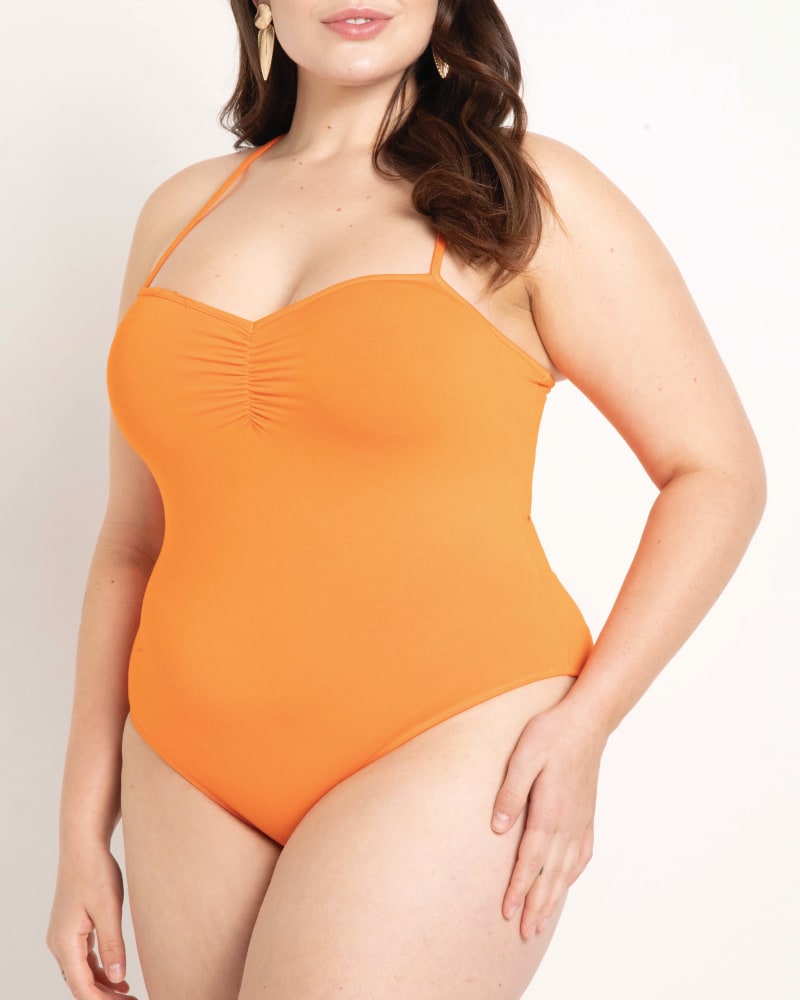 Front of a model wearing a size 14|16 Abigail Cross Strap Bodysuit in Exotic Orange by ELOQUII. | dia_product_style_image_id:204039